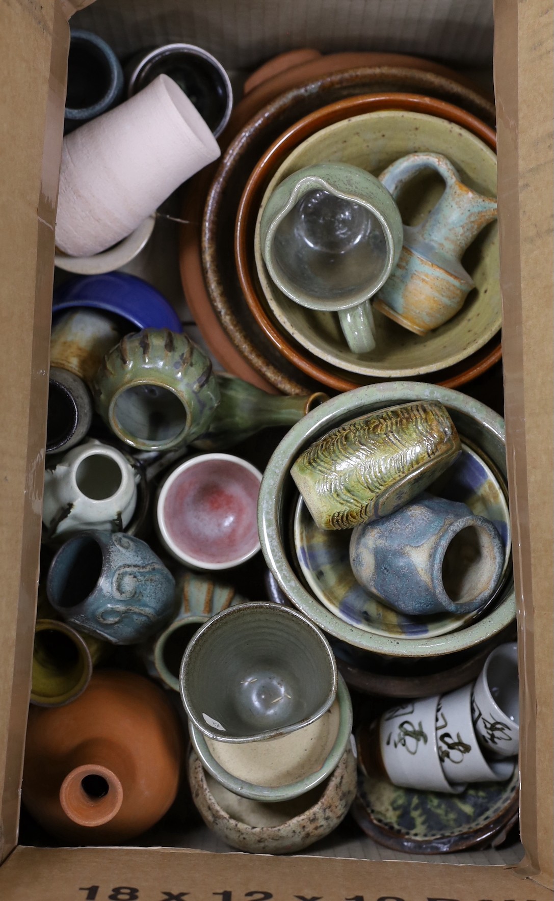 A large quantity of mixed studio pottery bowls, vases, etc.